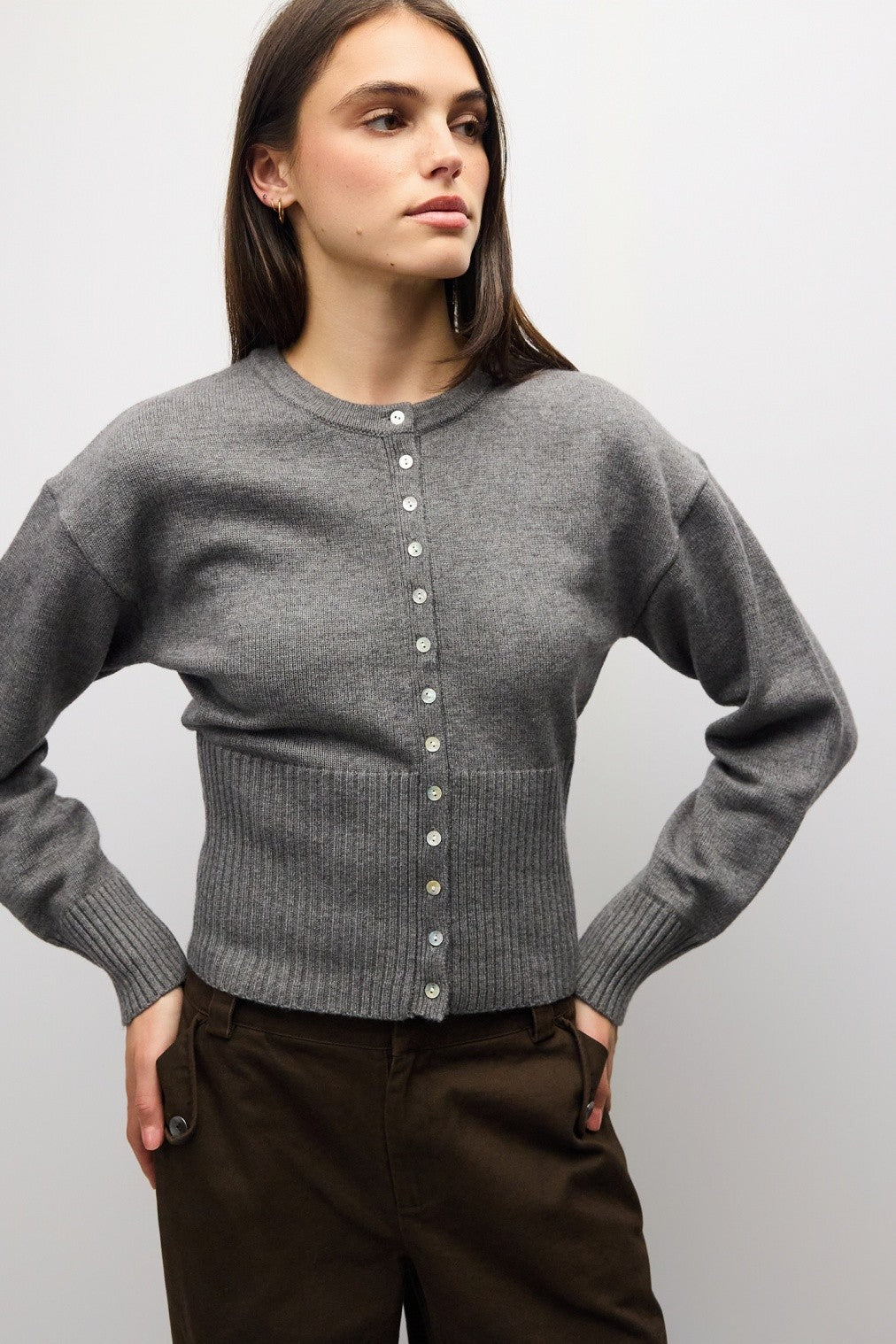 A timeless midweight knit cardigan featuring a polished crew neckline, full button front, and a flattering ribbed waist for effortless everyday sophistication.