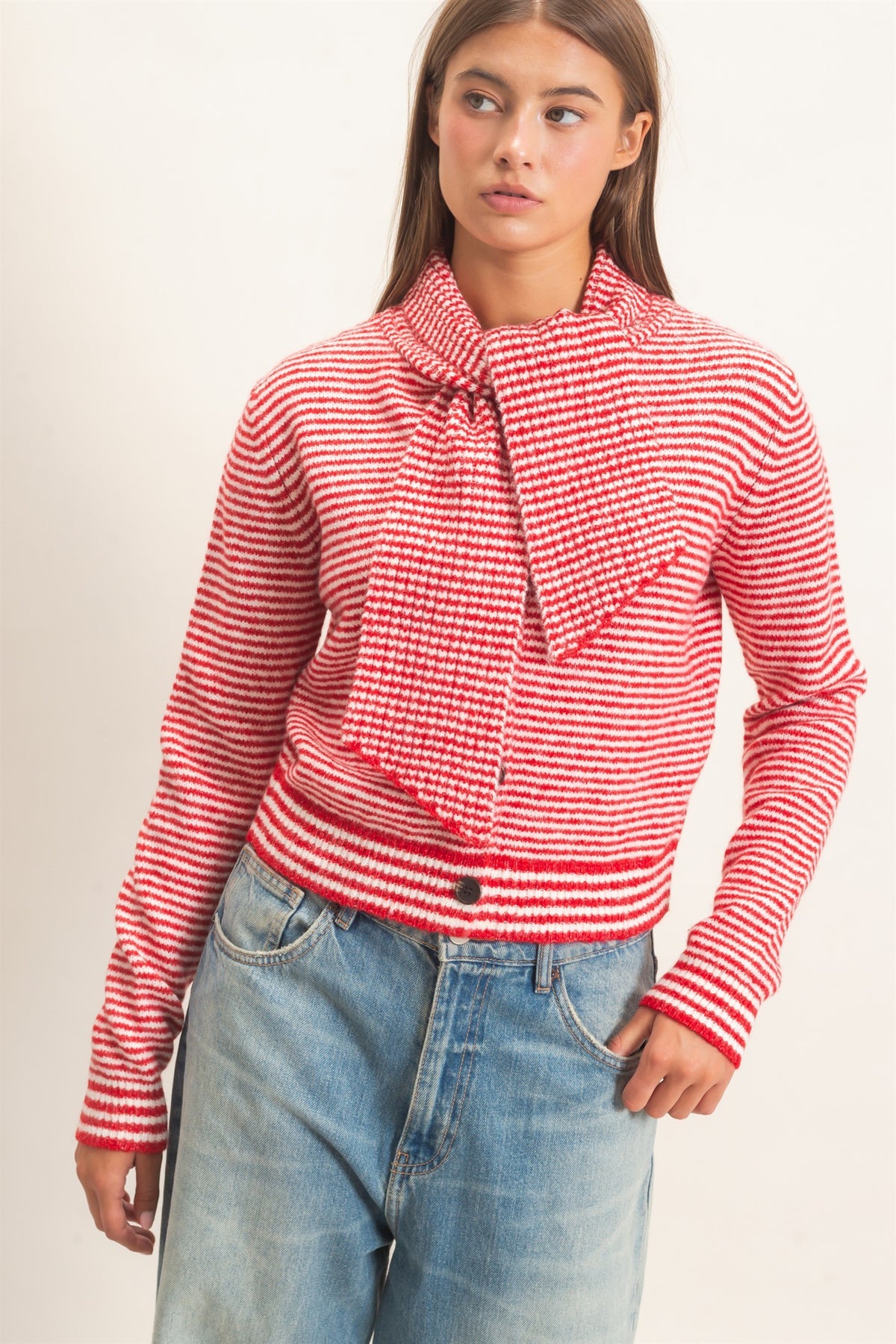 A chic striped knit sweater featuring a full button-up front and attached scarf neckline for a polished, modern layered look.

