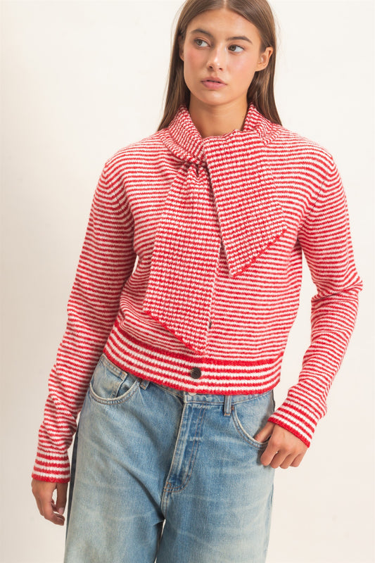 A chic striped knit sweater featuring a full button-up front and attached scarf neckline for a polished, modern layered look.

