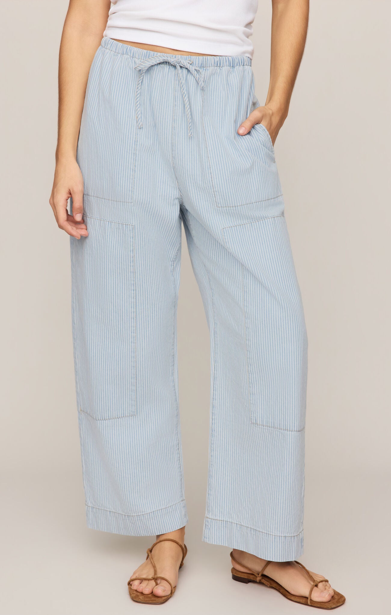 High-rise cotton denim pants featuring a striped print and tie-front detail for a stylish, comfortable everyday look.
