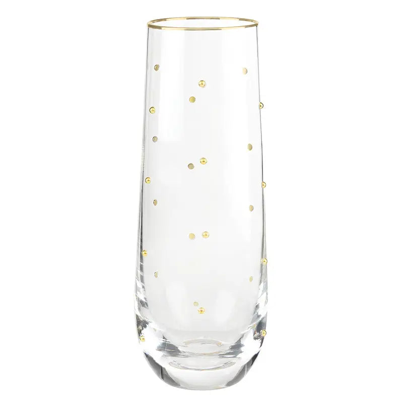 A clear glass champagne flute with delicate gold polka dots and a gold rim, shown against a plain white background.