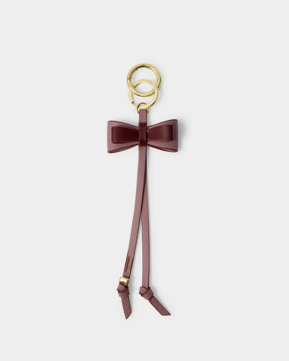 Our Bow Charm Keyring in Black Cherry features a sweet bow-shaped design, stamped with the sweet sentiment ‘Bestie’. Finished with gold-tone signature charm detailing, it makes the perfect gift for someone special.

