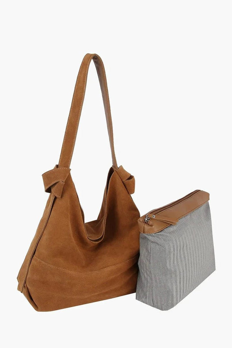 Elevate your everyday style with a luxurious genuine suede hobo bag featuring a roomy silhouette, magnetic snap closure, and detachable pouch for effortless organization.

