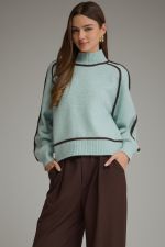 A cozy mock neck sweater featuring statement balloon sleeves, contrast trim throughout, and ribbed finishing for a polished seasonal look.

