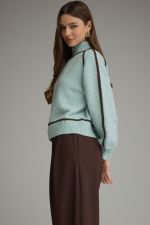 A cozy mock neck sweater featuring statement balloon sleeves, contrast trim throughout, and ribbed finishing for a polished seasonal look.

