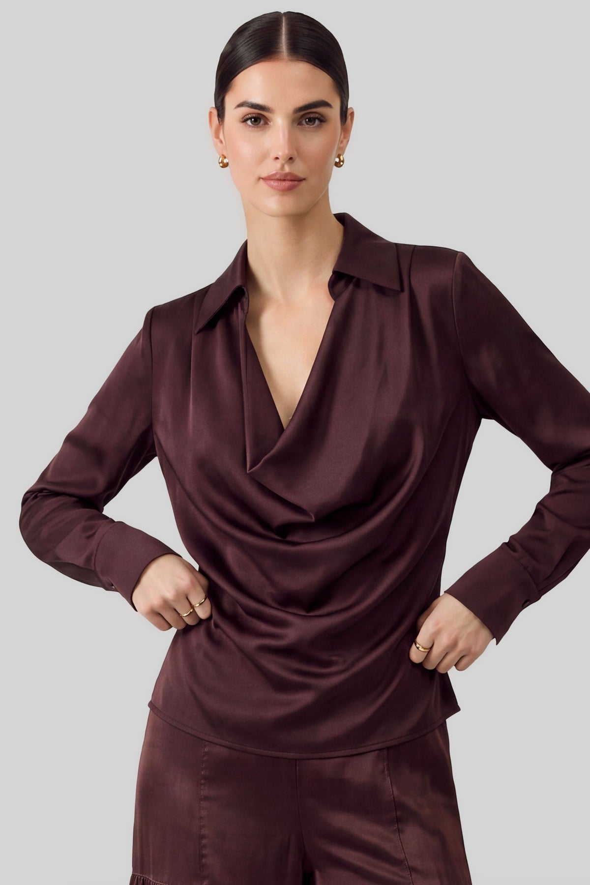 An effortlessly elegant blouse featuring a spread collar with a softly draped cowl neckline and classic long sleeves.