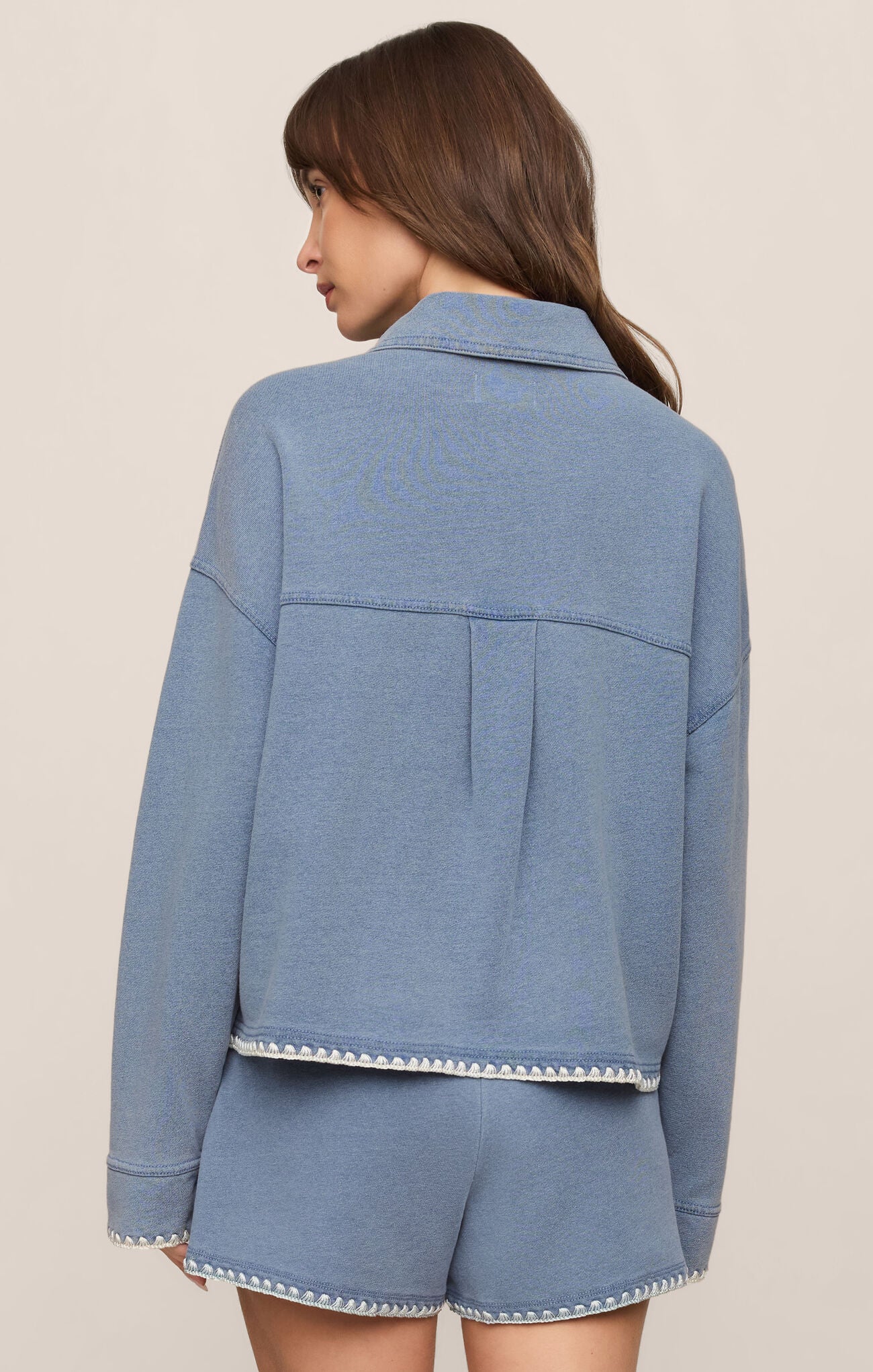 back of cropped denim-inspired jacket crafted from soft French terry knit for comfortable layering with a modern casual feel.