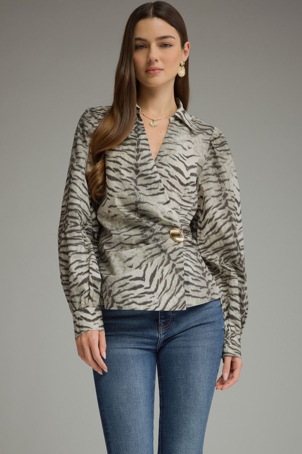 Make a bold style statement with this animal print crossover top featuring voluminous puff sleeves, a flattering buckle waist, and a feminine V-neckline.

