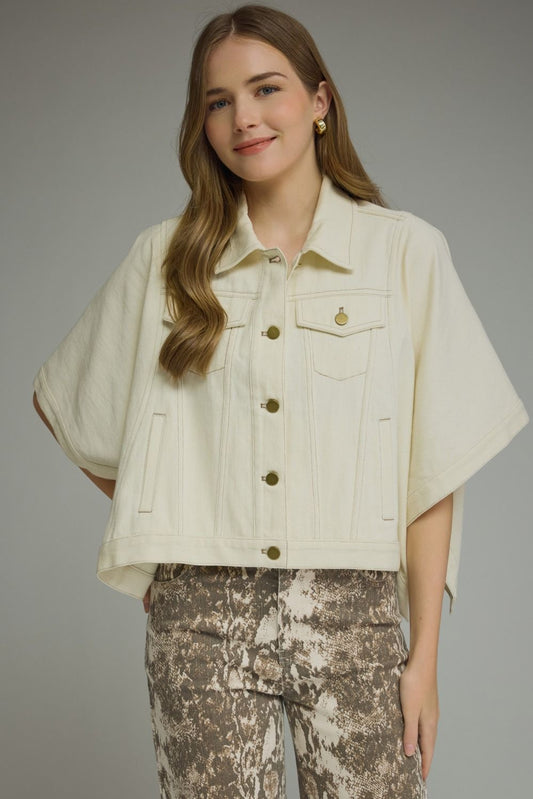A versatile denim short sleeve jacket with snap-button closures, multiple pockets, and a timeless structured silhouette made for effortless layering.

