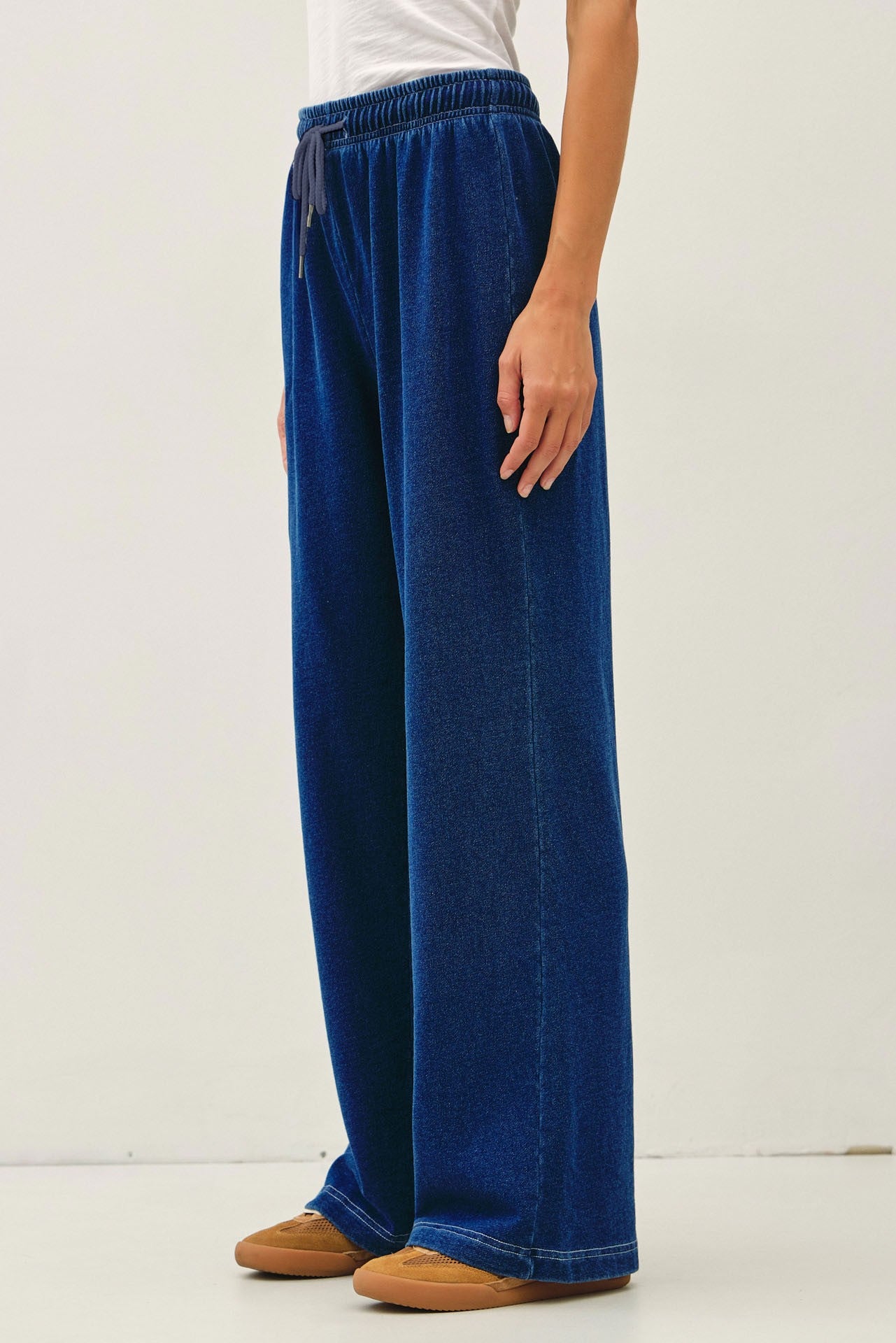Comfort meets effortless style in these lightweight knit denim wide leg pants featuring an elastic drawstring waist and relaxed lounge fit.

