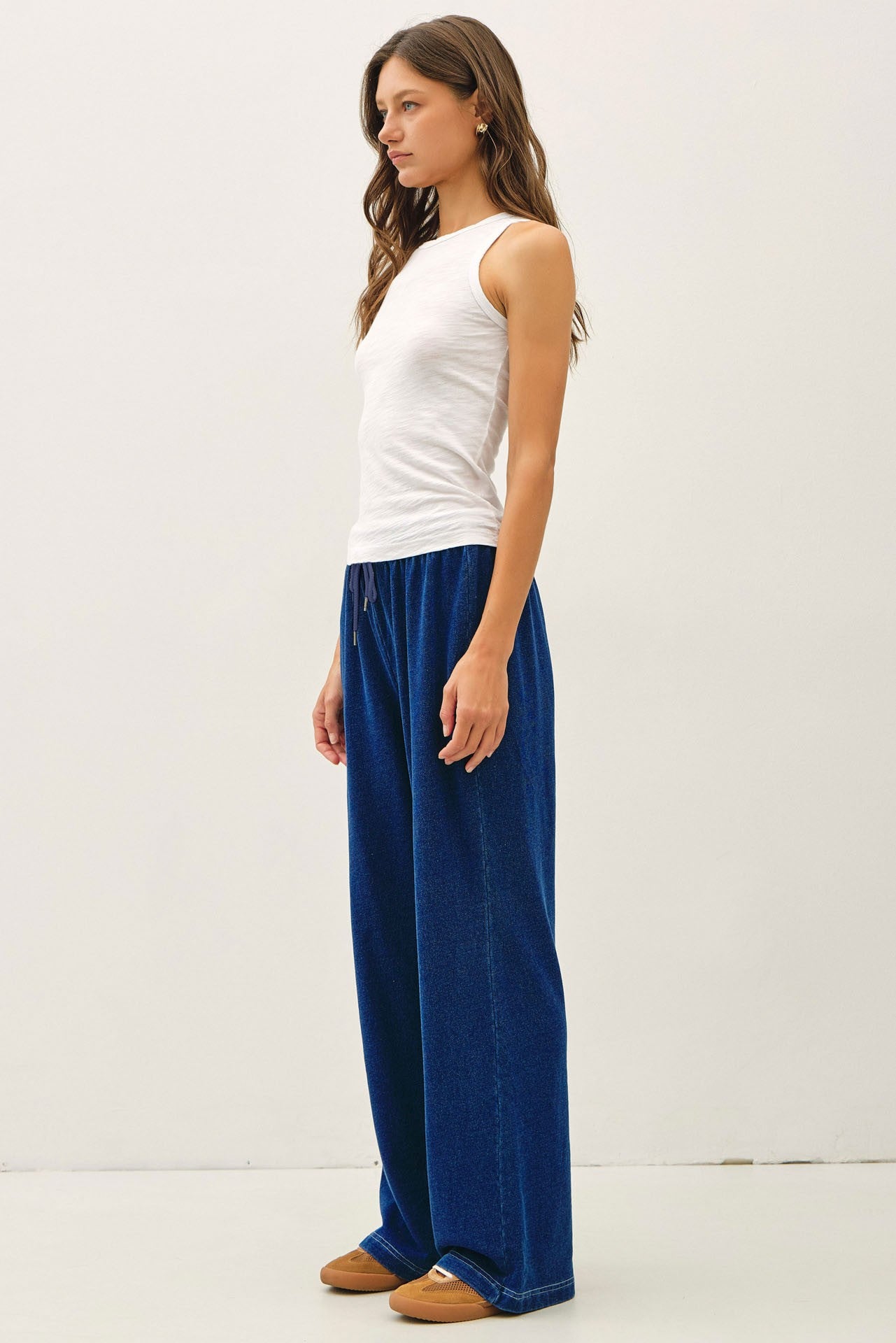 Comfort meets effortless style in these lightweight knit denim wide leg pants featuring an elastic drawstring waist and relaxed lounge fit.
