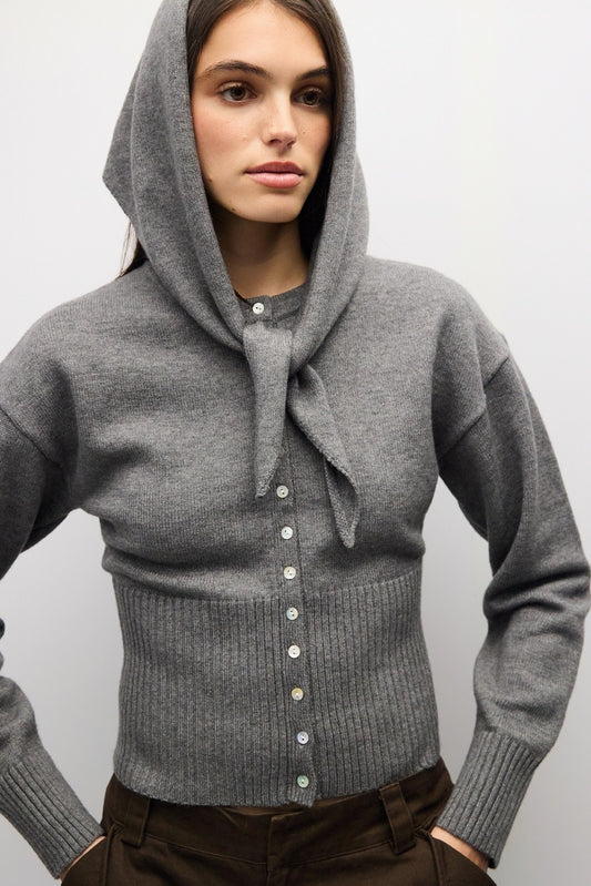 A timeless midweight knit cardigan featuring a polished crew neckline, full button front, and a flattering ribbed waist for effortless everyday sophistication.