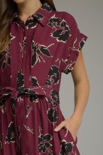 A feminine floral midi dress featuring a button-front bodice, adjustable self-tie waist, and flowing silhouette for timeless everyday elegance.