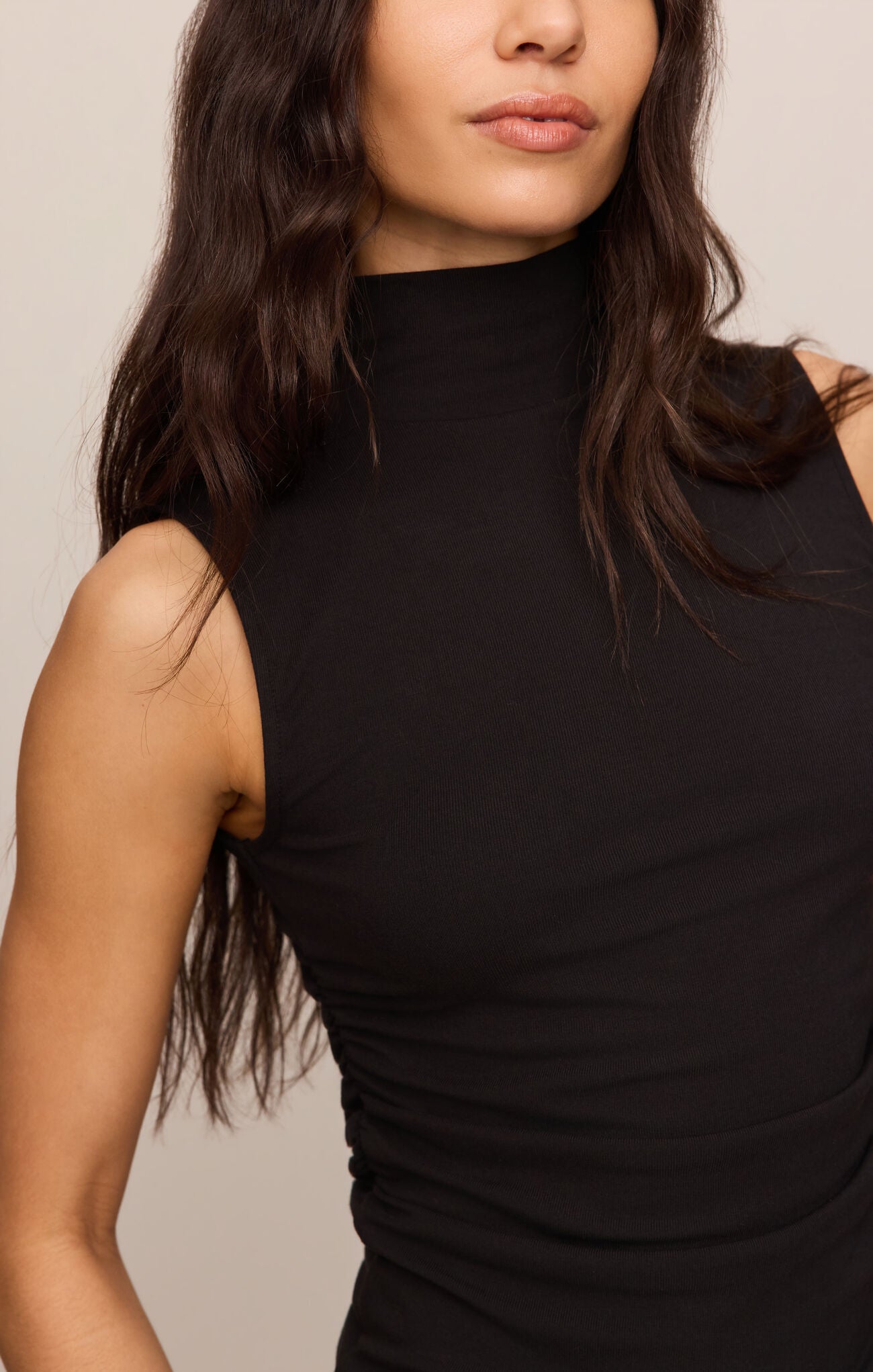 A sleek sleeveless turleneck crafted from ultra-soft second skin baby rib fabric for a smooth, flattering fit you'll wear year-round.
