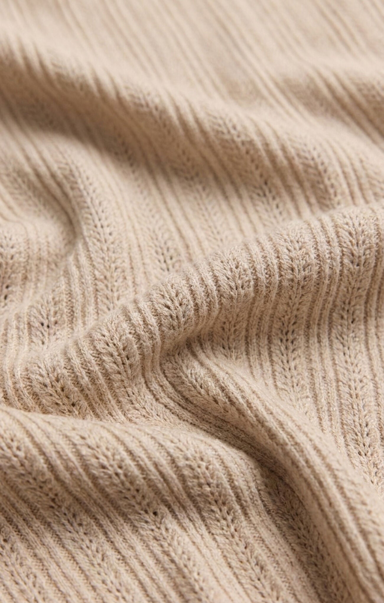 A luxuriously soft button-front cardigan featuring a flattering V-neckline and lightweight knit construction for timeless, versatile layering.
