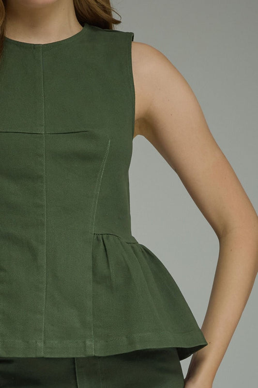 A timeless sleeveless peplum top featuring a flattering silhouette, clean lines, and lightweight woven fabric for effortlessly polished style.