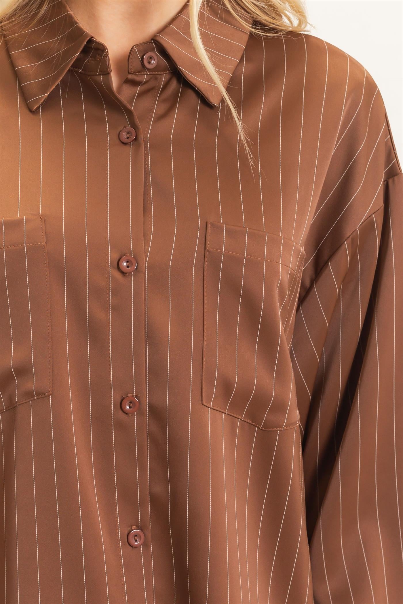 A relaxed striped button-up blouse with a classic spread collar, chest pocket, and button cuffs for effortless polished style.