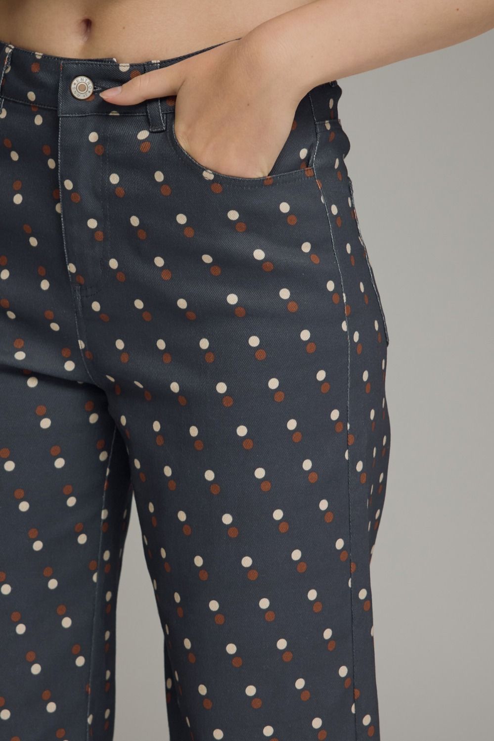 Make every outfit memorable with these playful polka dot denim pants featuring a flattering straight-leg silhouette and feminine ruffle hems.