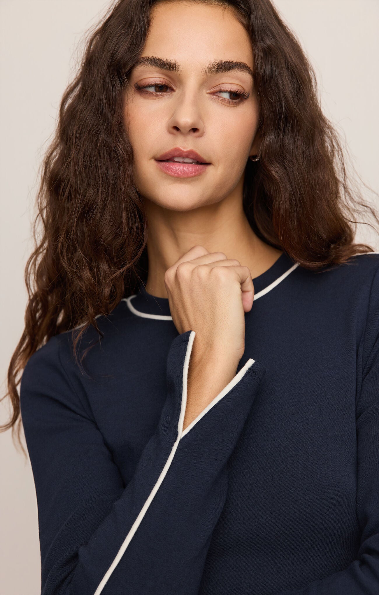 A refined long sleeve knit pullover featuring crisp white contrast trim at the neckline, cuffs, and sleeves for a timeless, elevated look.
