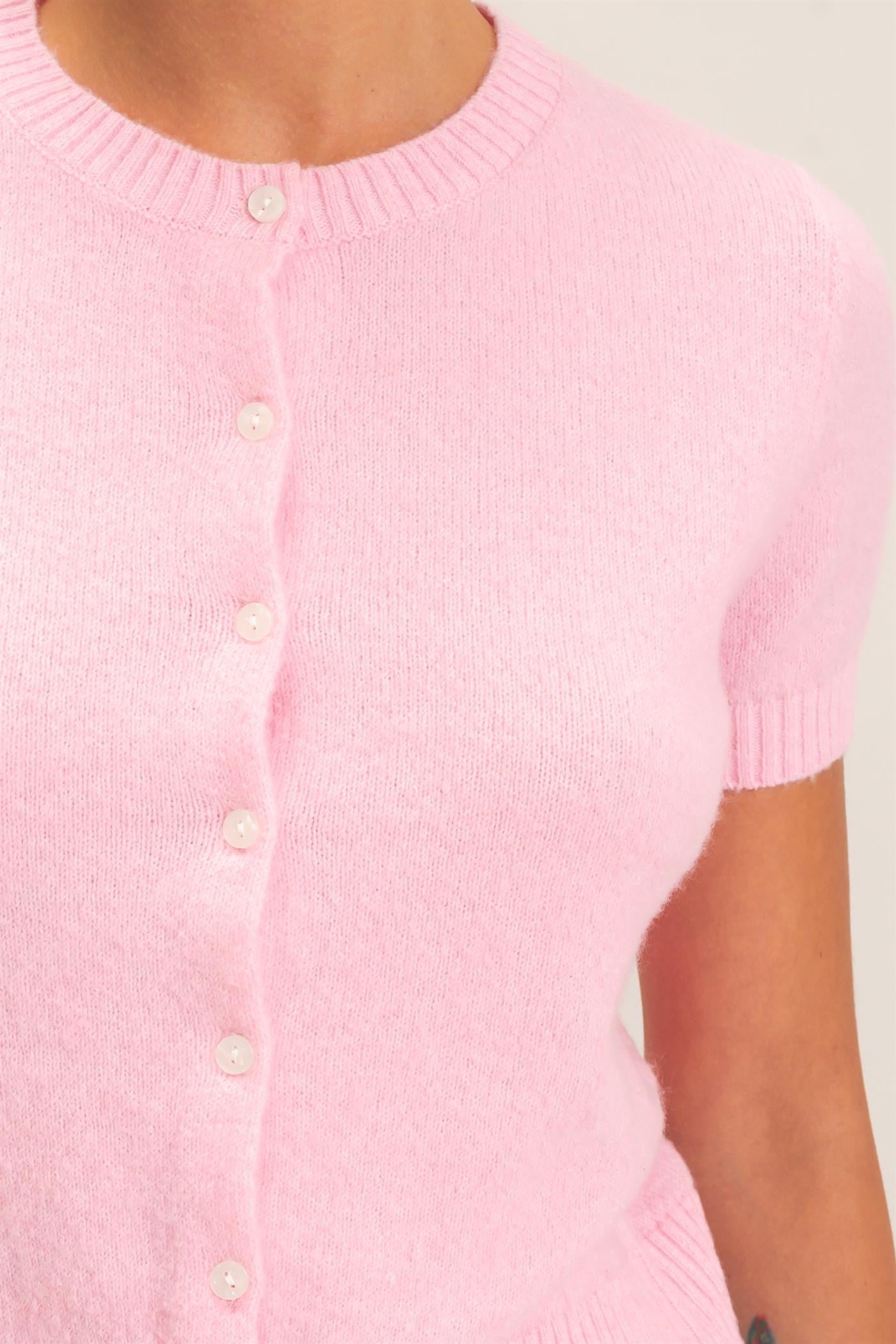 A polished, figure-flattering short-sleeve sweater with classic ribbed texture and button-front styling that makes effortless everyday dressing feel elevated.