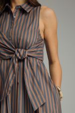 A timeless striped midi dress featuring a collared neckline, self-tie front, and sleeveless silhouette for effortless warm-weather style.
