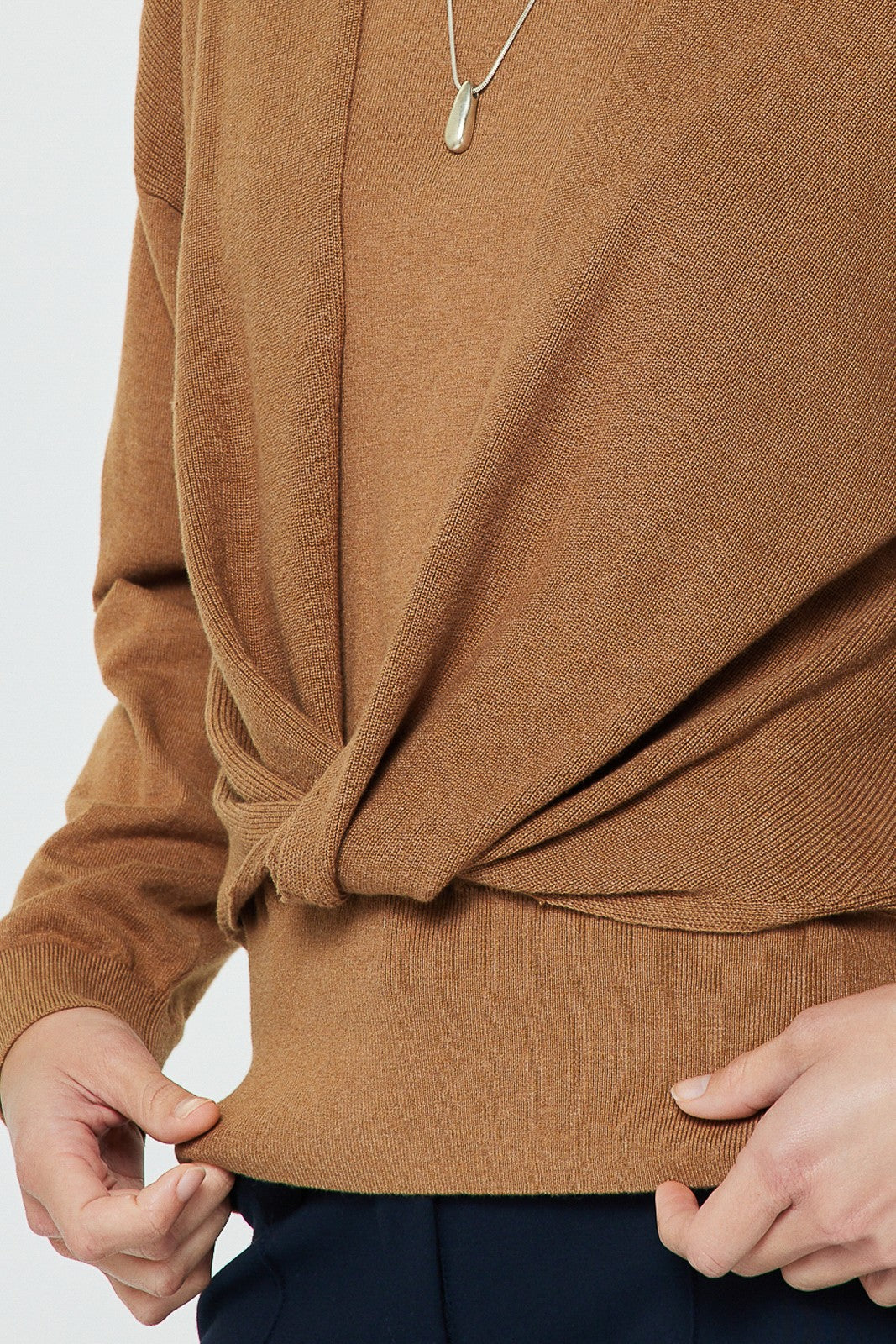 A beautifully soft knit sweater with a relaxed fit, elegant twist-front detail, and flowing dolman sleeves for effortless everyday style.