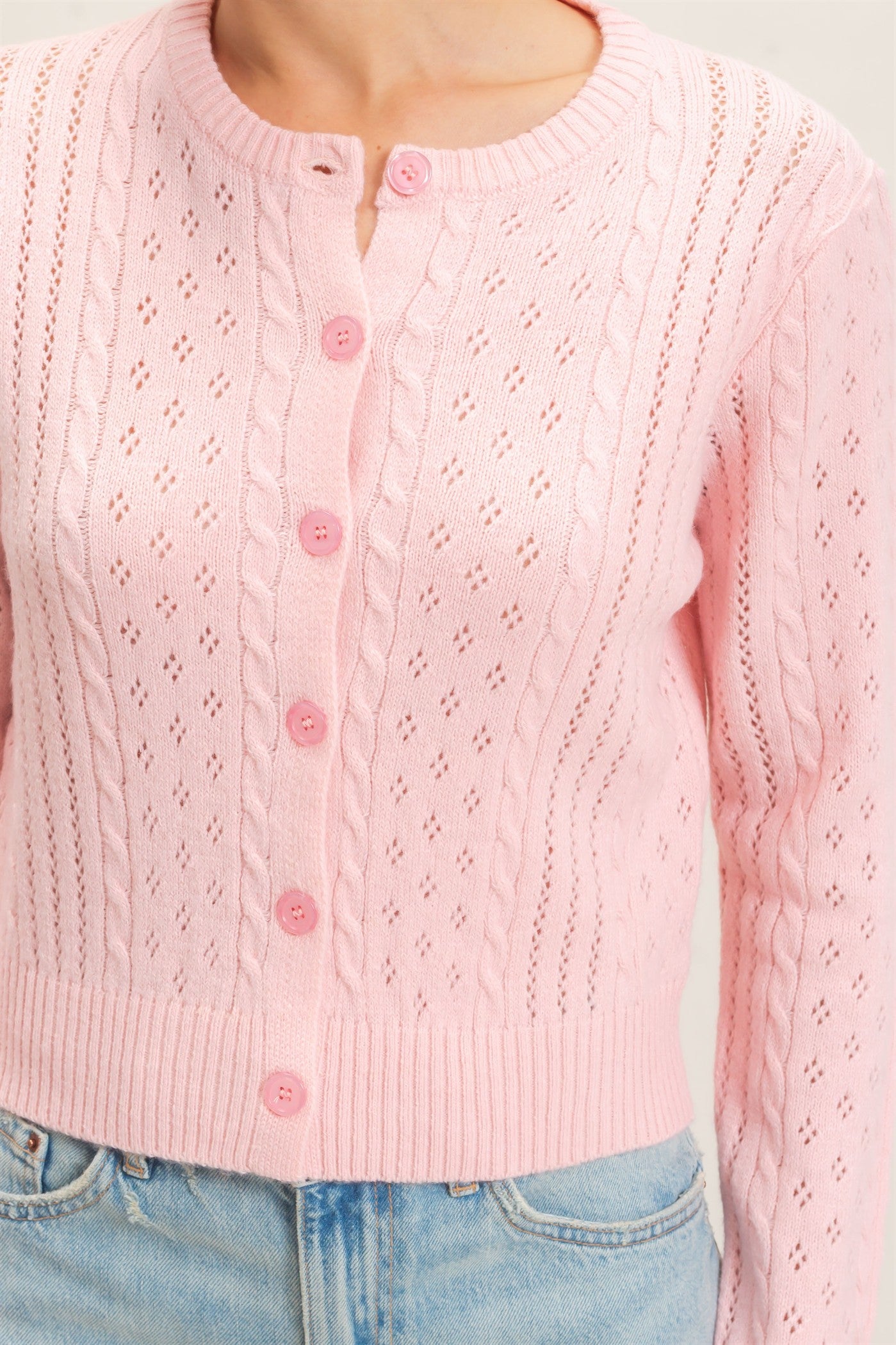 A timeless cable knit cardigan with a classic crew neckline, button-front closure, and textured detailing for cozy, polished style.