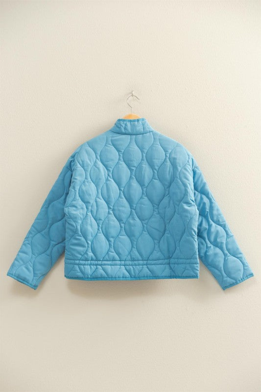 The Evadne Quilted Drawstring Jacket delivers cozy structure with a modern relaxed fit.