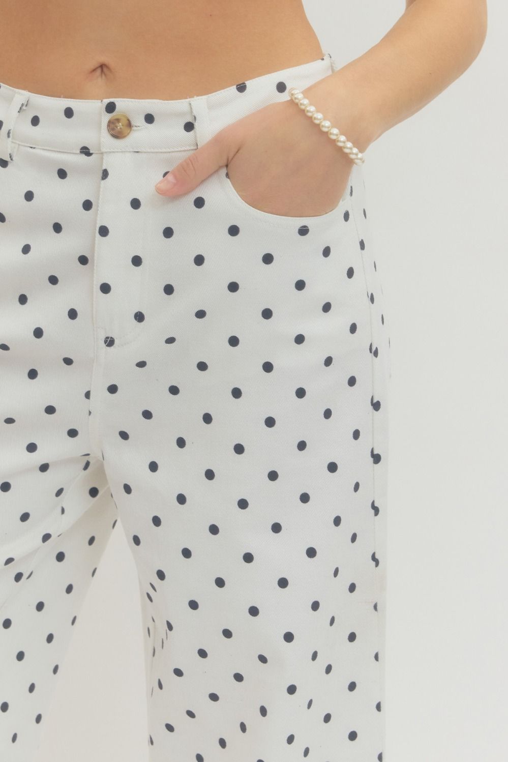 wide-leg pants with polka dot print, button and zip-fly closure, and functional pockets