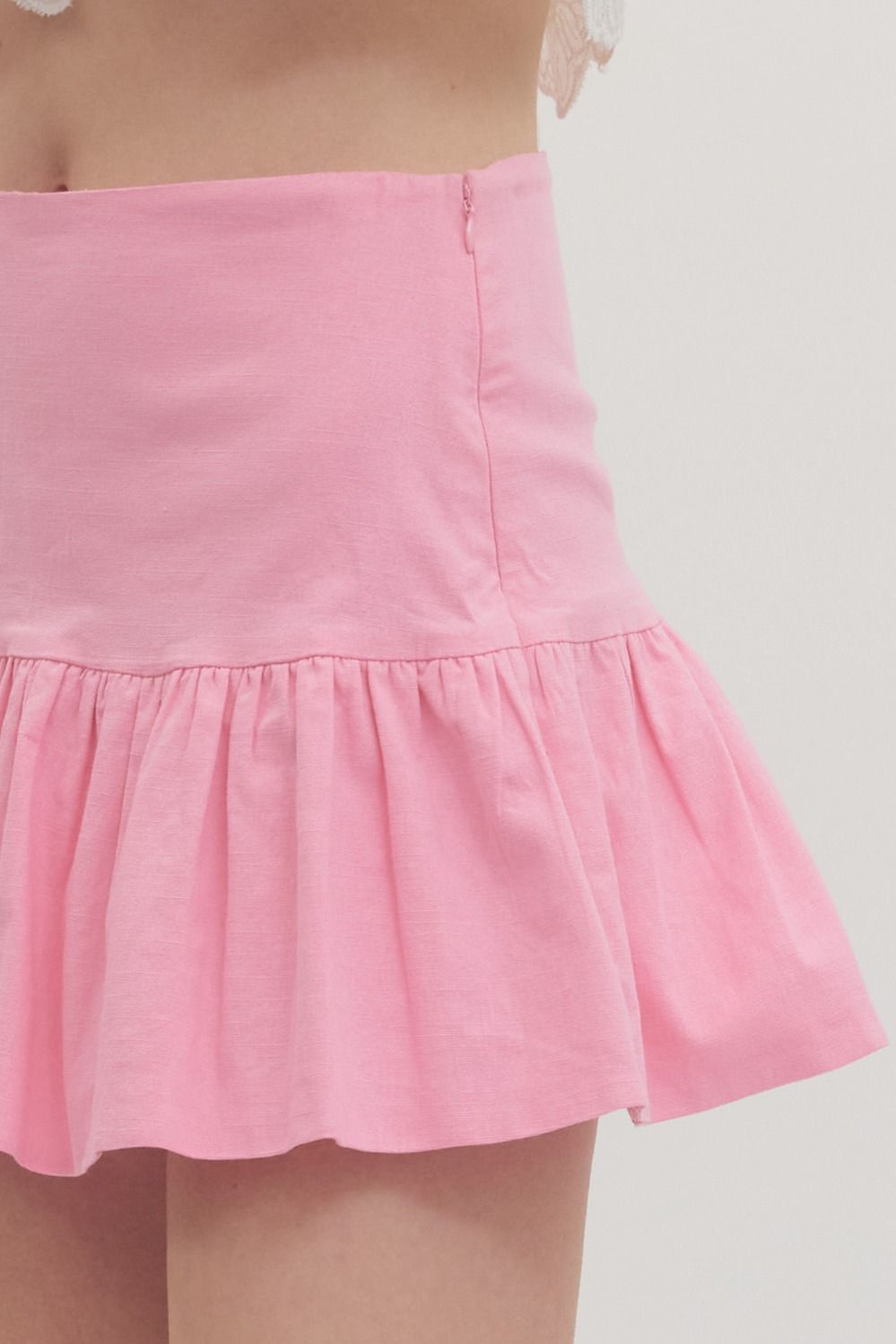 high-waist skirt with ruffle hem, side zipper, and built-in shorts lining