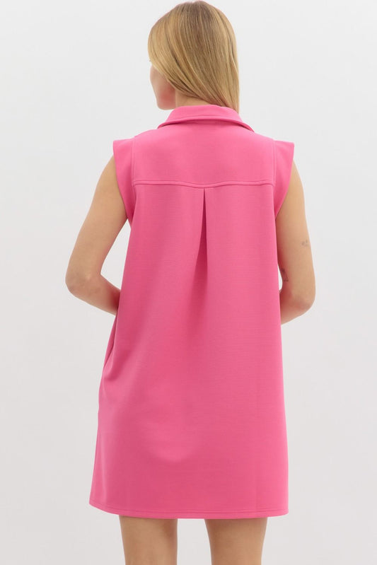 featuring a textured knit fabric, a sharp collared V-neckline, and side pockets for everyday practicality.