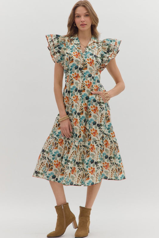 Airy and graceful, the Honora midi dress pairs a botanical print with pleats, flutter sleeves, and timeless femininity.