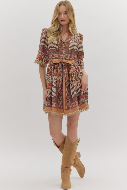 Bold and feminine, the Beatrix mini dress mixes botanical print, contrast trim, and lace accents with a flattering, easy-to-wear silhouette.
