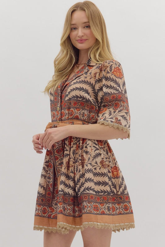 Bold and feminine, the Beatrix mini dress mixes botanical print, contrast trim, and lace accents with a flattering, easy-to-wear silhouette.
