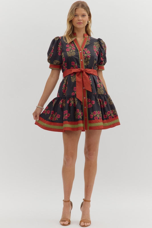 Bright and feminine, the Rosamund mini dress combines a floral print, puff sleeves, and ruffle hem with colorful banded accents.