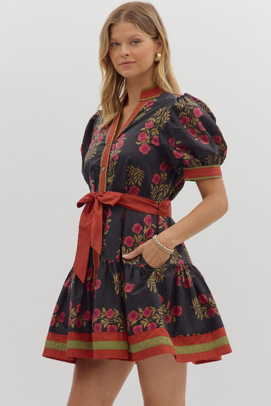Bright and feminine, the Rosamund mini dress combines a floral print, puff sleeves, and ruffle hem with colorful banded accents.