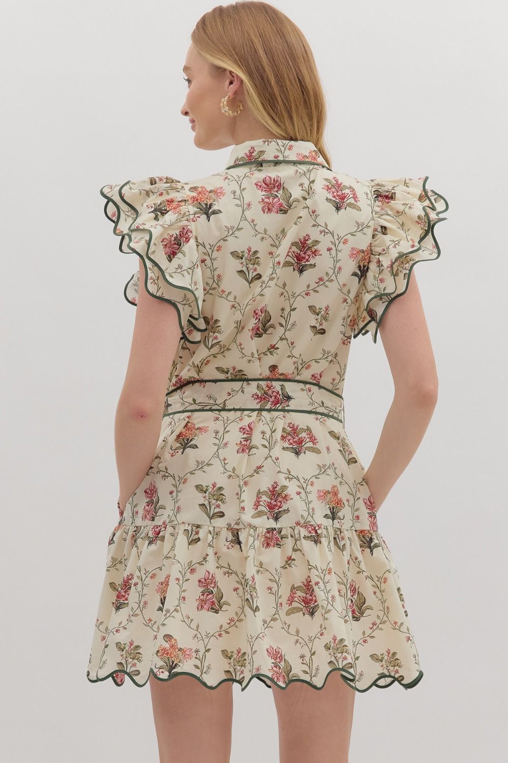 Feminine and polished, the Mabel mini dress pairs flutter sleeves and a tiered skirt with crisp piping and a waist-defining tie.