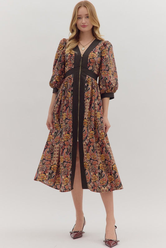 Charming and versatile, the Verena midi dress pairs a bold paisley print with striped trim, puff sleeves, and practical pockets.