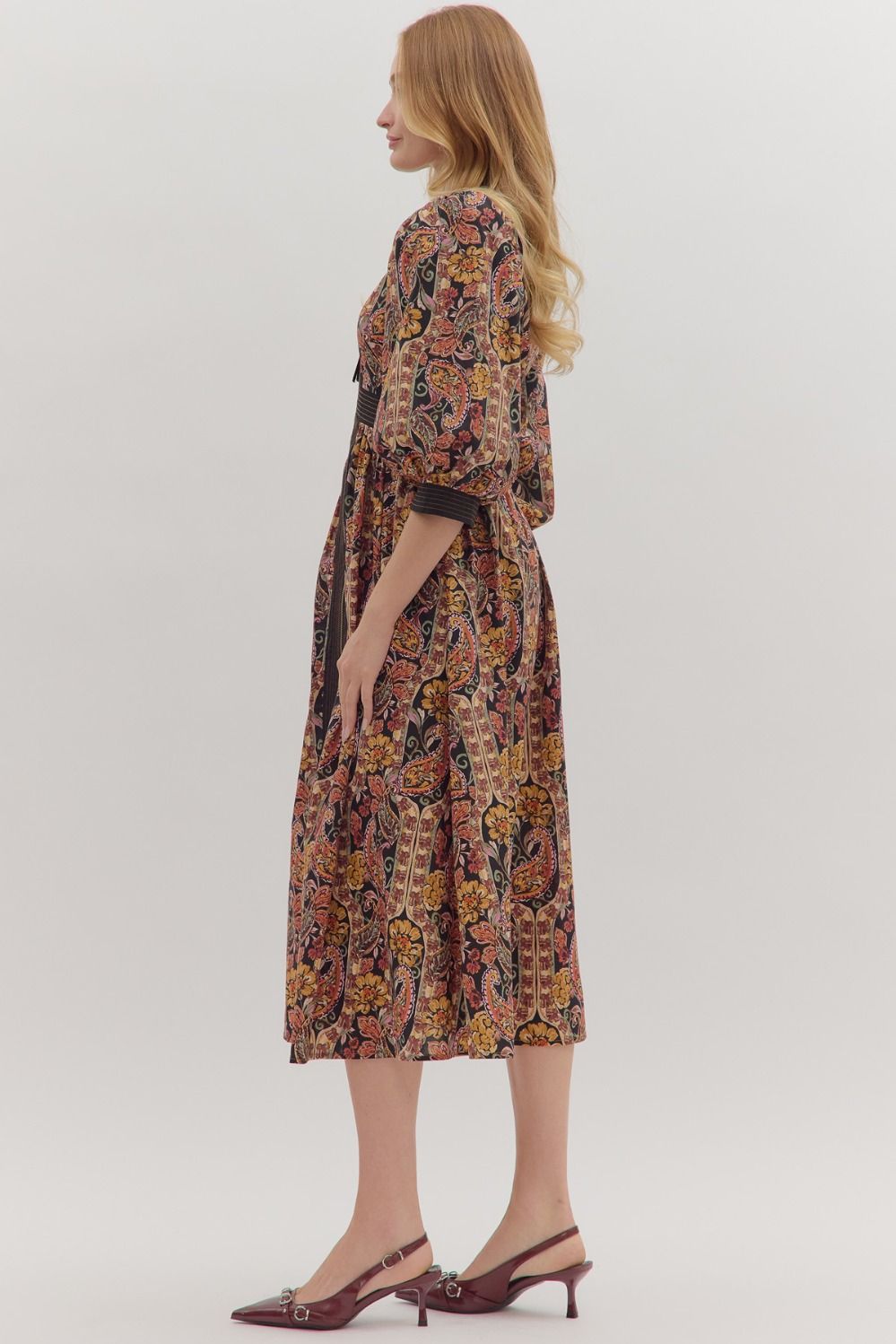 Charming and versatile, the Verena midi dress pairs a bold paisley print with striped trim, puff sleeves, and practical pockets.