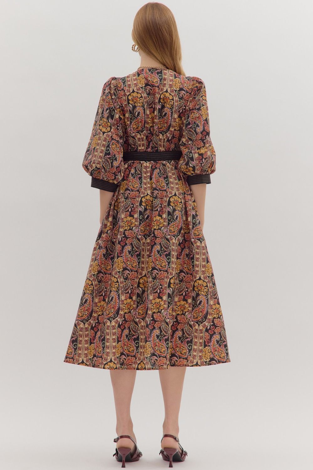 Charming and versatile, the Verena midi dress pairs a bold paisley print with striped trim, puff sleeves, and practical pockets.