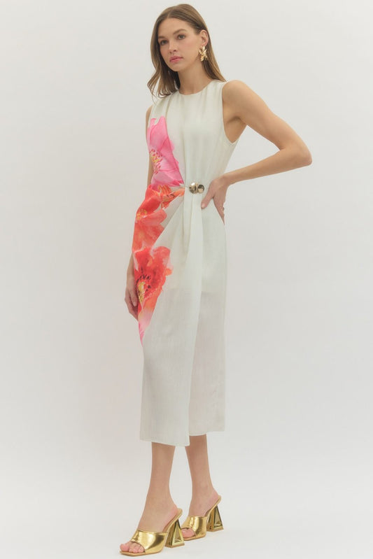 Floral sleeveless midi dress with draped front panel and decorative ring detail.