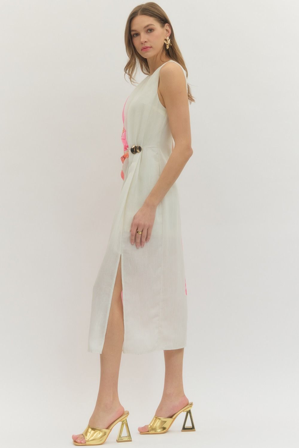 Floral sleeveless midi dress with draped front panel and decorative ring detail.