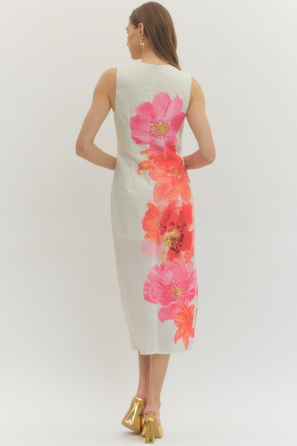 Floral sleeveless midi dress with draped front panel and decorative ring detail.