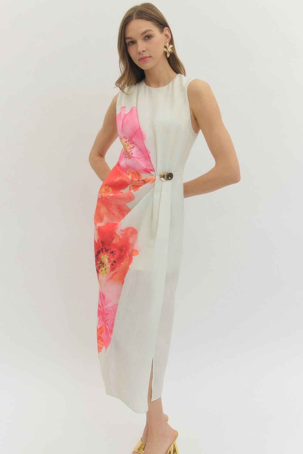 Floral sleeveless midi dress with draped front panel and decorative ring detail.