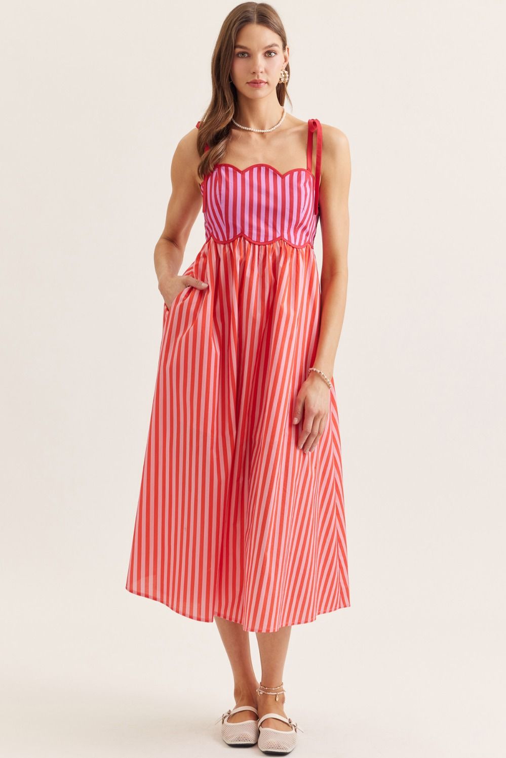lightweight striped cotton midi dress with a scallop neckline, tie straps, and a flattering smocked back.