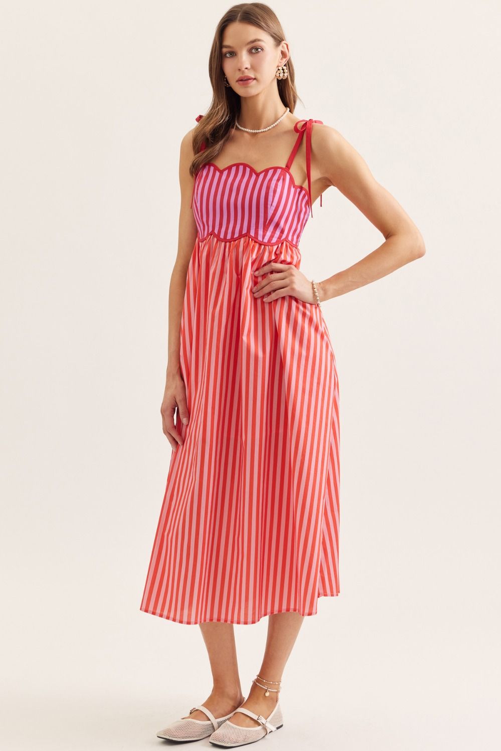 lightweight striped cotton midi dress with a scallop neckline, tie straps, and a flattering smocked back.