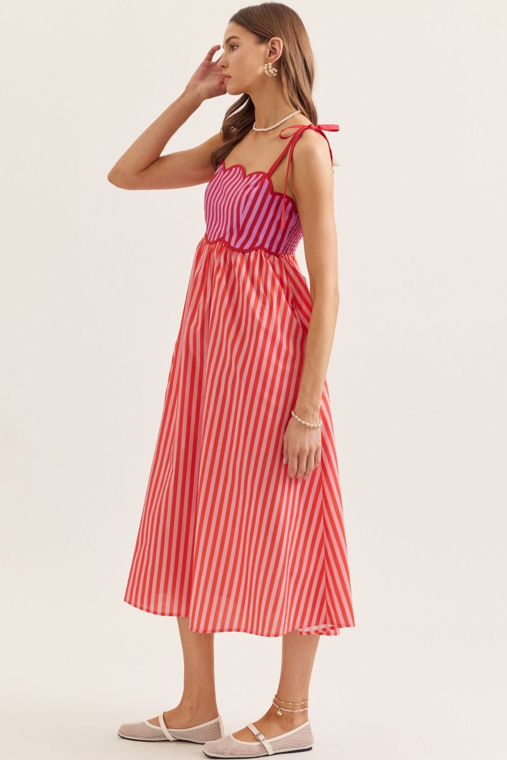 lightweight striped cotton midi dress with a scallop neckline, tie straps, and a flattering smocked back.