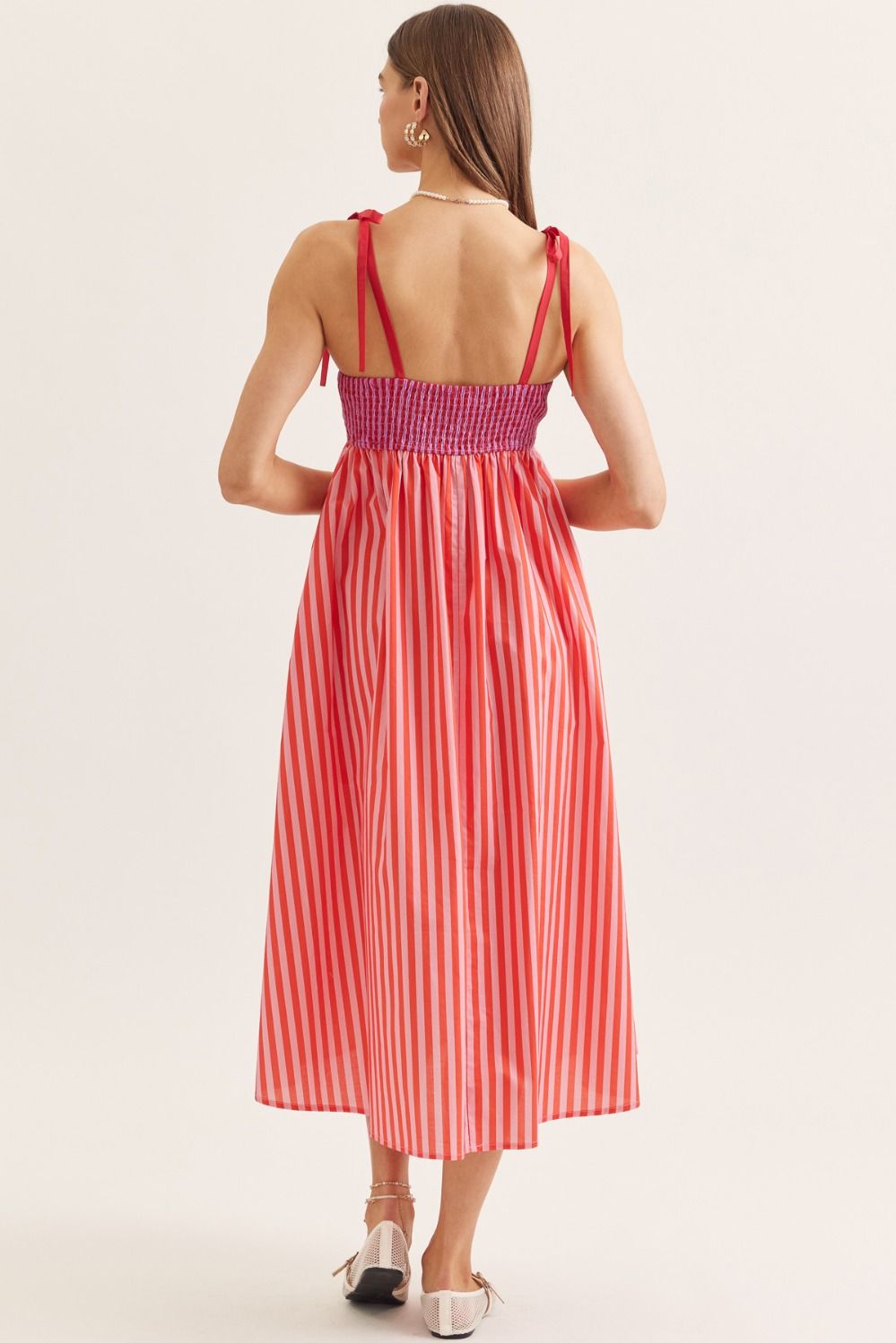 lightweight striped cotton midi dress with a scallop neckline, tie straps, and a flattering smocked back.