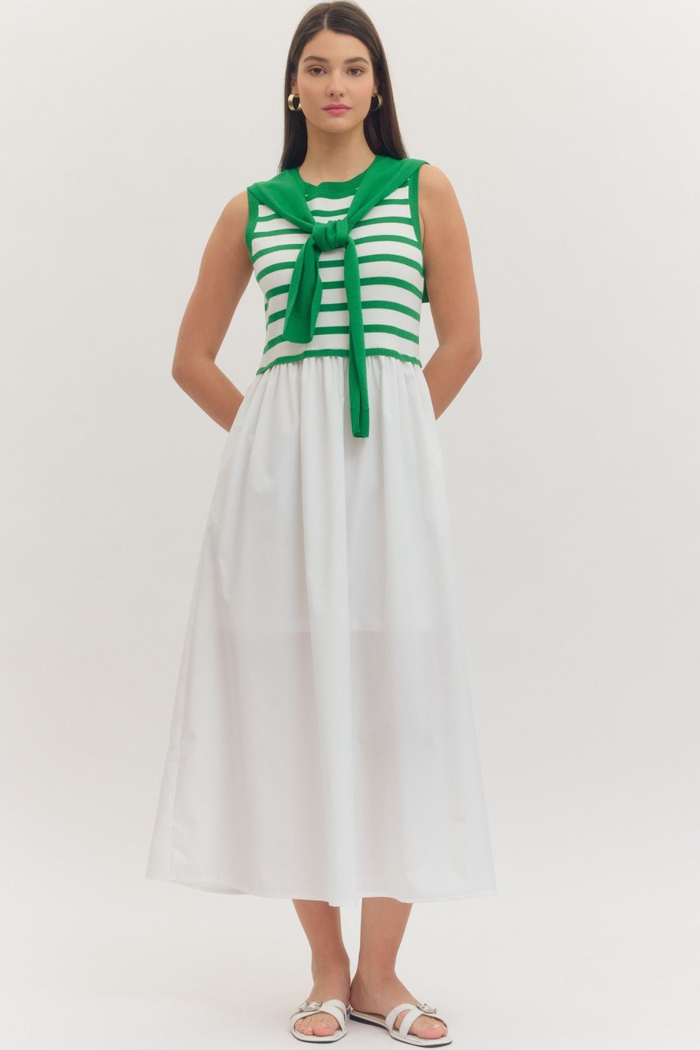 Striped sleeveless midi dress with contrast sweater overlay
