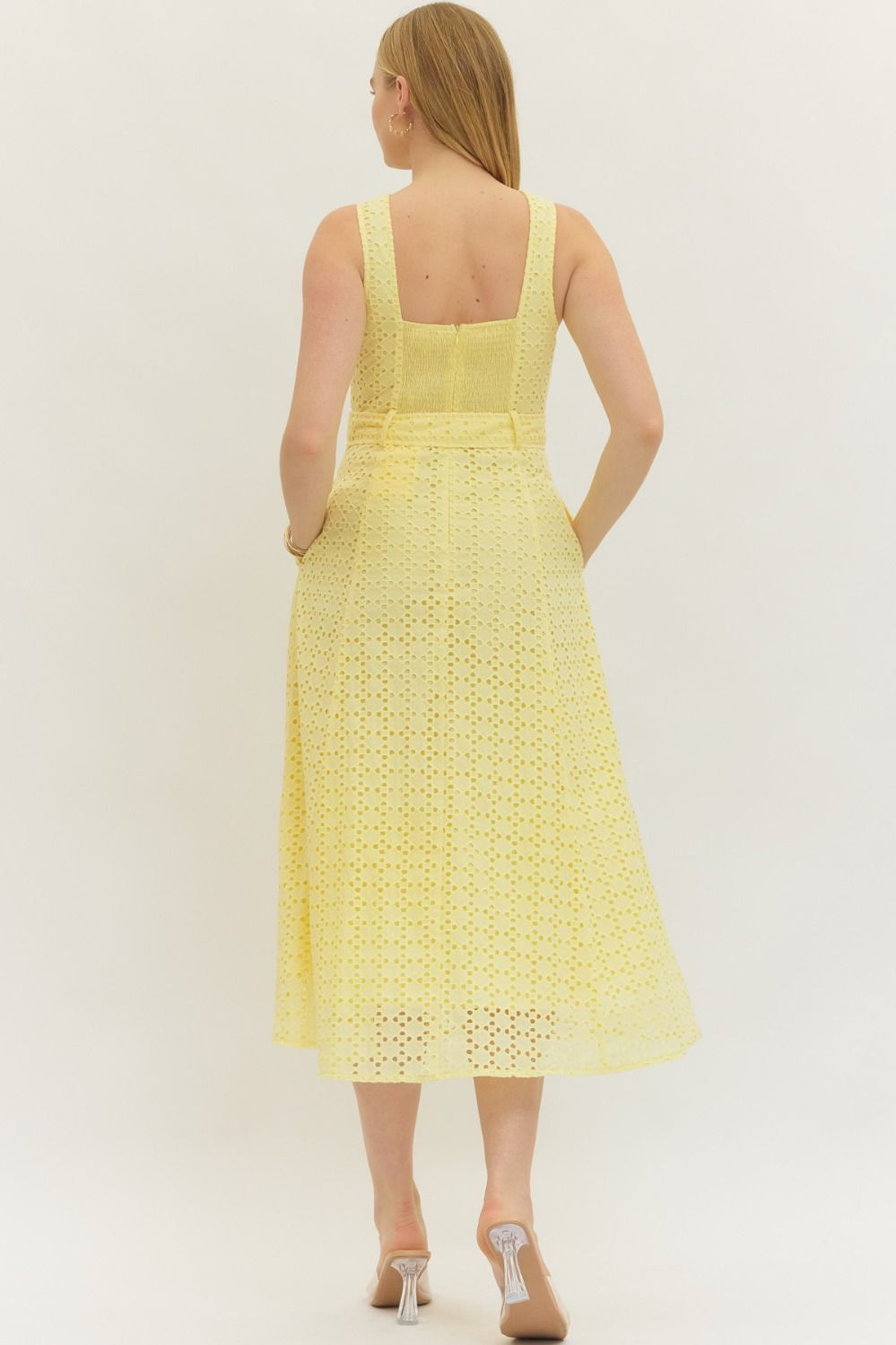 cotton eyelet midi dress with a belted waist, smocked back, and elegant, structured silhouette.